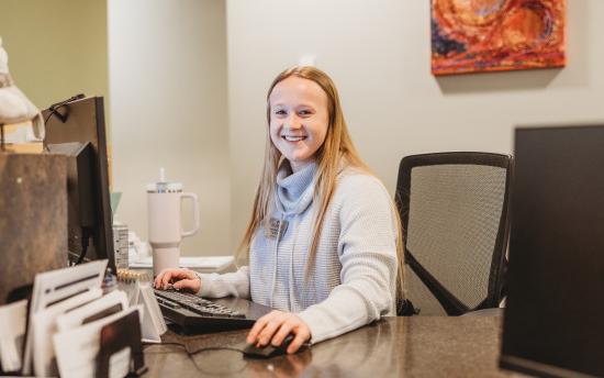 Photo of the front desk with a smiling face that greets you as you walk into camp us