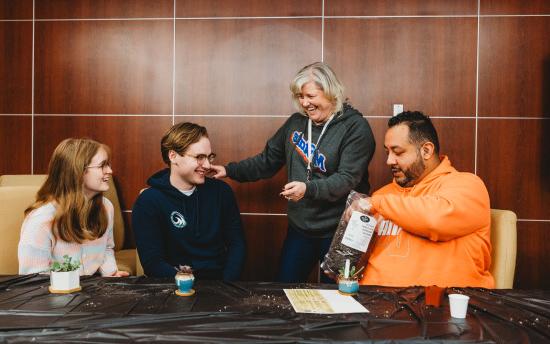 Photo of a small group of people at a succulent planting event